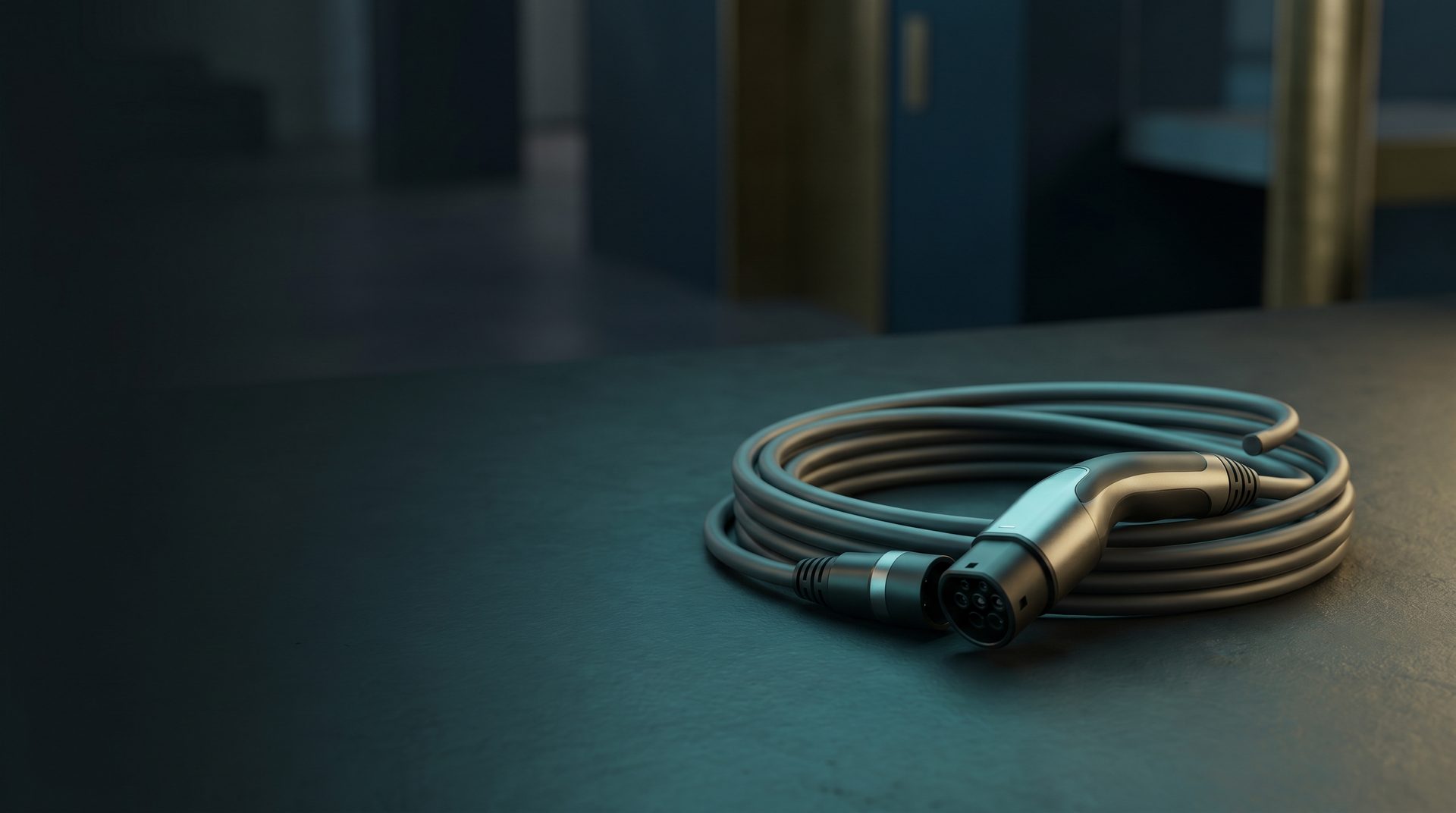 Close-up of an EV charging cable and connector on a dark surface